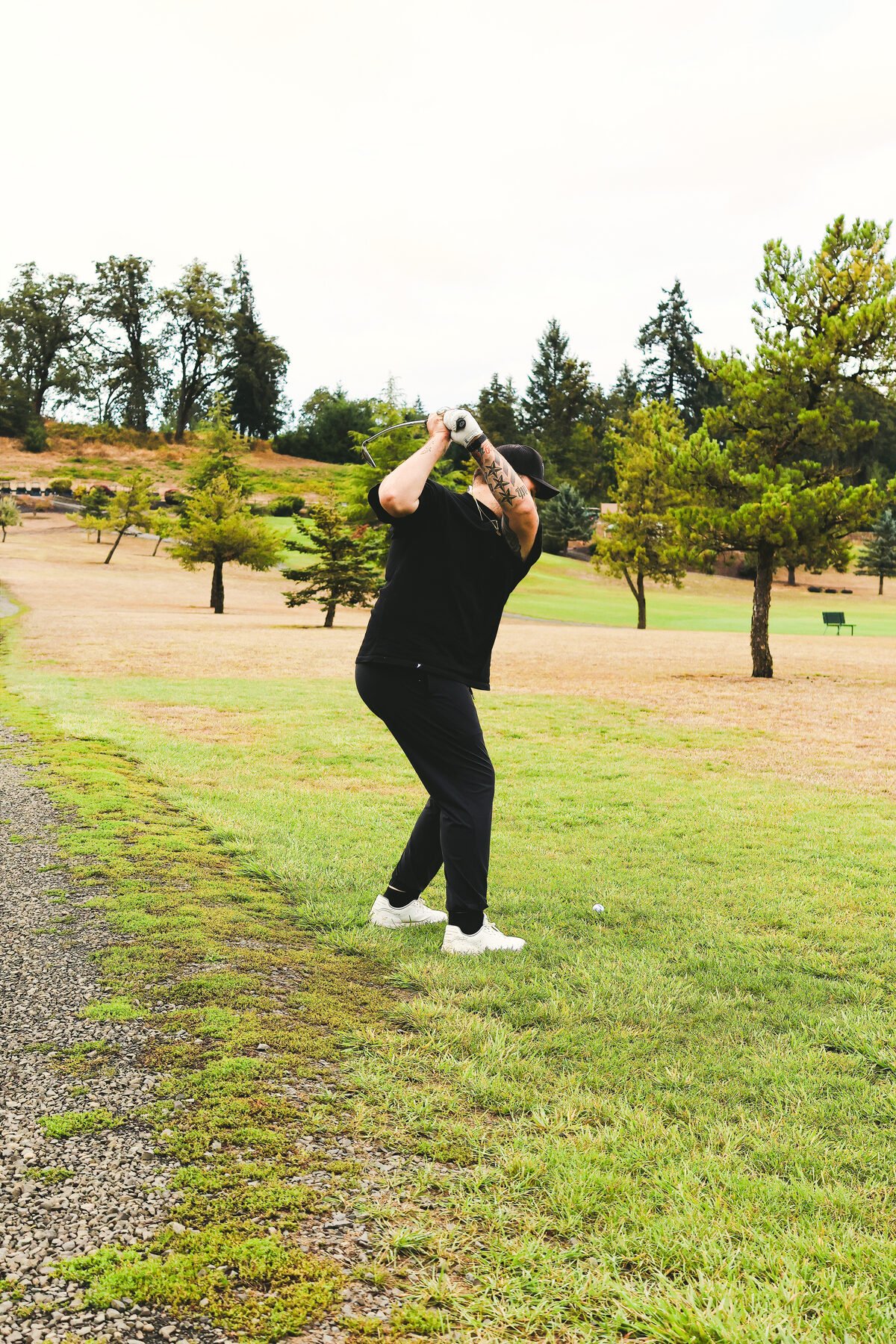 Swing from a cart path, trees running away behind