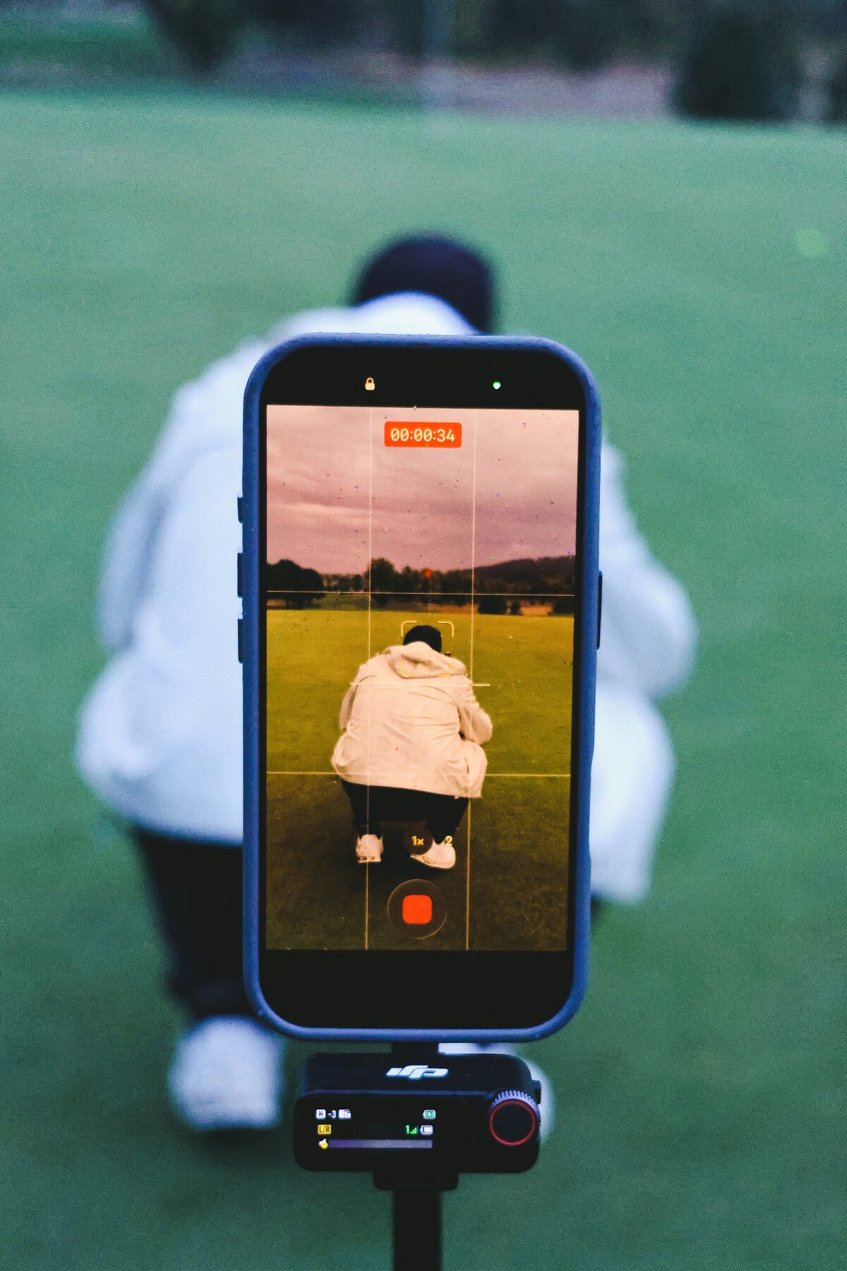 A phone on a gimbal filming a putt, the shot behind the shot