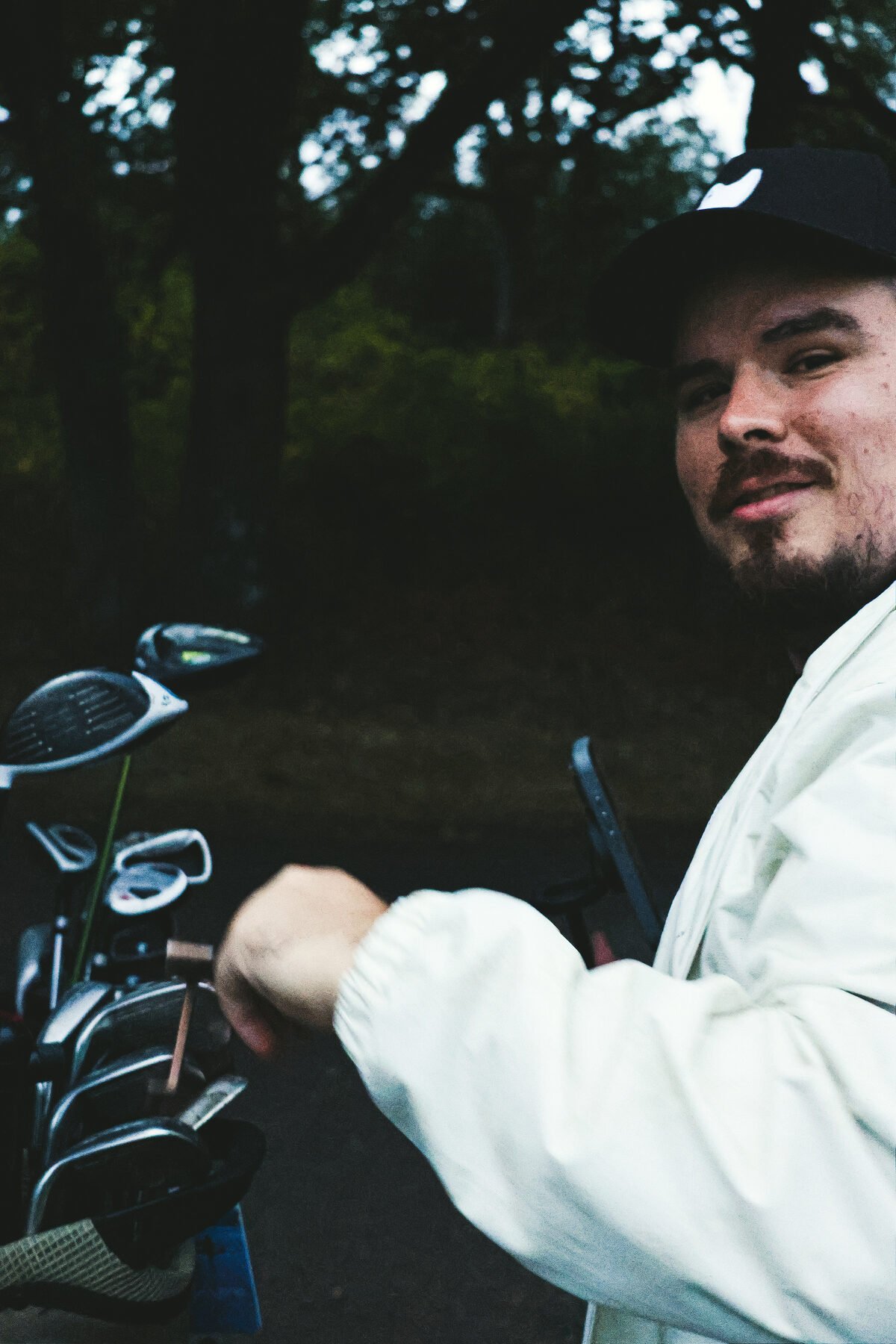 A hand pulling a club from the bag